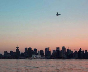 Vancouver City Skyline at Dusk with one of many float planes arriving.